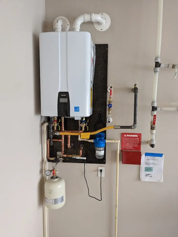 Professional plumber installing copper piping in a Shelton home